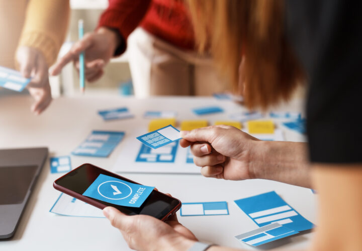 Group of programers working on mobile development UX UI