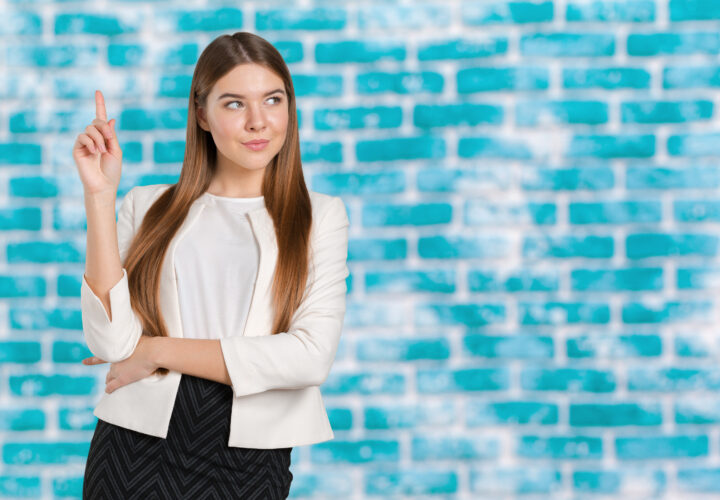 Businesswoman with finger point aside